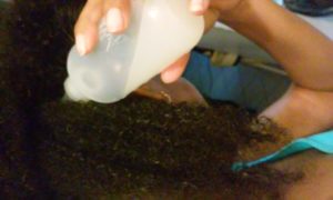 Using an Applicator Bottle to Put Rice Water in My Hair